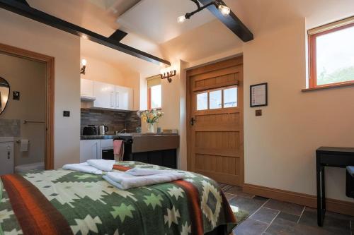 a bedroom with a bed and a kitchen at Cosy countryside retreat, Weiser in Buckinghamshire