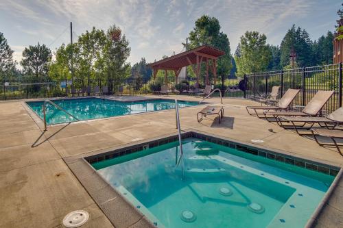 a swimming pool with two chairs and a gazebo at Suncadia Resort Condo Balcony and Golf Course Views in Cle Elum