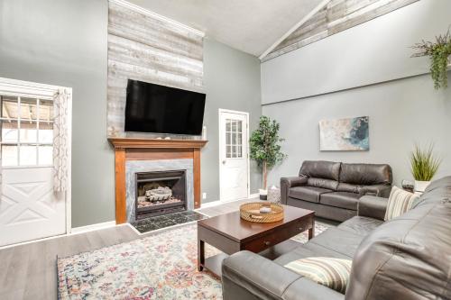 a living room with a couch and a fireplace at All-Season Indian Lake Home with Covered Deck! in Huntsville