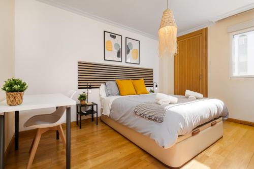 a white bedroom with a bed and a desk at Nordik Apartments Urban - Playa Virginia "Hanko" in Málaga