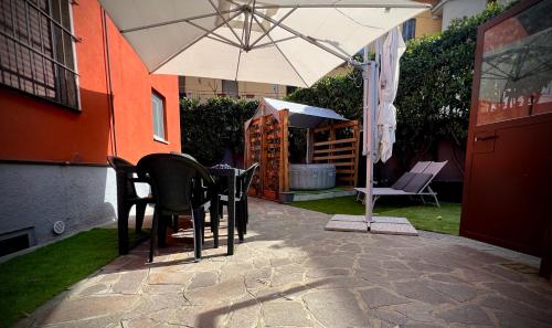 a table and chairs under an umbrella on a patio at La Perla in Monza