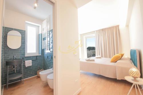 a bedroom with a bed and a bathroom at Alberobbè luxury rooms in Alberobello