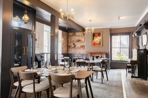 a restaurant with tables and chairs in a room at The King Of Prussia in Fowey