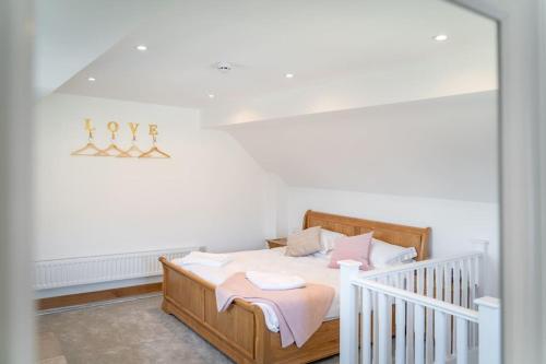 a bedroom with a bed with a crib in it at Old Dairy Cottage - Cosy and Luxurious! in Buckinghamshire