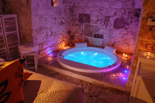 a large bath tub in a room with lights at La Terrazza Sulla Rupe Relais in Ostuni