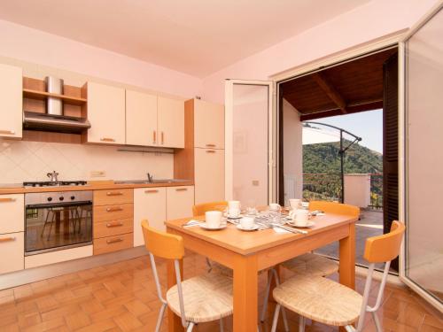 een keuken met een houten tafel en gele stoelen bij Apartment Tramonto su Capri by Interhome in Massa Lubrense