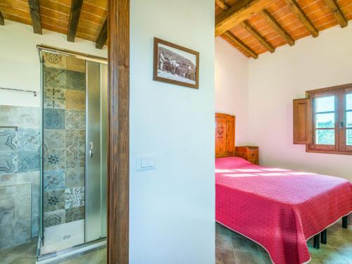 a bedroom with a bed and a glass shower at Holiday Home Villino PERO by Interhome in Montescudaio