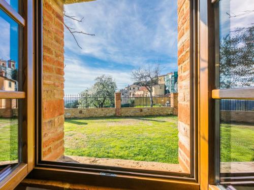 an open window with a view of a yard at Holiday Home Villino PERO by Interhome in Montescudaio