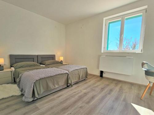 a bedroom with two beds and a window at Holiday Home Skelin by Interhome in Drinovci
