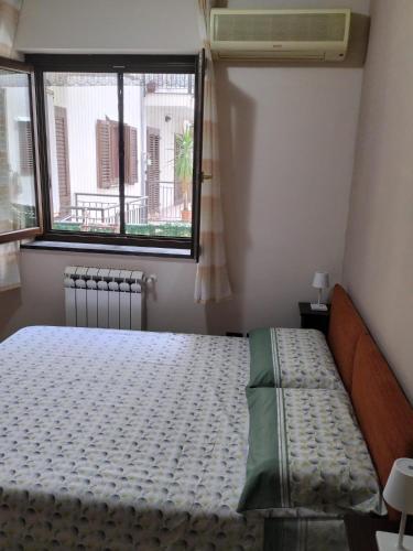 a bedroom with a bed and a window at Turi house in Messina