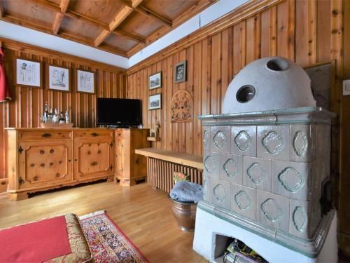 a fireplace in a living room with wooden walls at Chalet Chalet Franca by Interhome in Madesimo