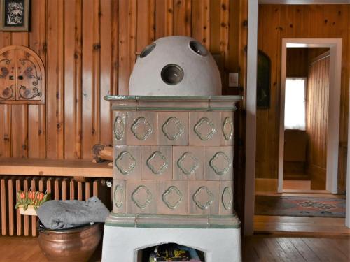a woodburning stove in a room in a house at Chalet Chalet Franca by Interhome in Madesimo