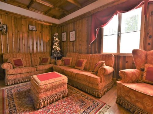 a living room with couches and chairs and a window at Chalet Chalet Franca by Interhome in Madesimo