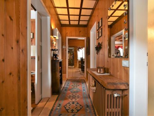 a kitchen with wooden walls and a floor with a rug at Chalet Chalet Franca by Interhome in Madesimo