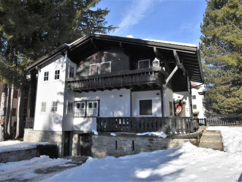 a house with a balcony in the snow at Chalet Chalet Franca by Interhome in Madesimo