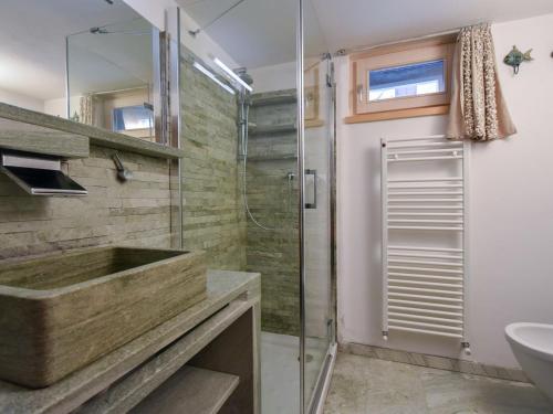 a bathroom with a glass shower and a sink at Chalet Chalet Franca by Interhome in Madesimo