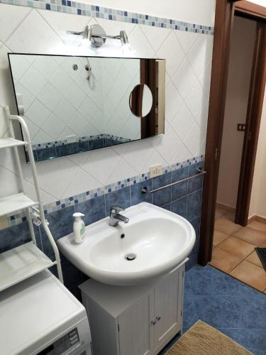 a bathroom with a sink and a mirror at Turi house in Messina
