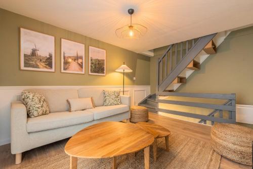 a living room with a couch and a table at 1 bedroom courtyard house typical of Old Lille in Lille
