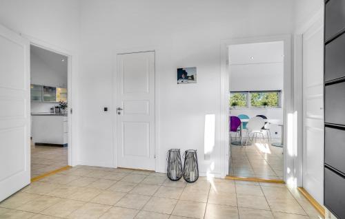 a white room with two pairs of shoes on the floor at Amazing Home In Jerup With Wifi in Jerup