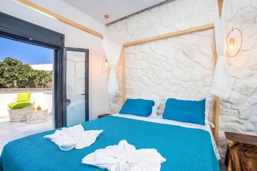 a bedroom with a blue bed with towels on it at Ferienhaus für 4 Personen ca 79 m in Faliraki, Ägäis Rhodos in Faliraki