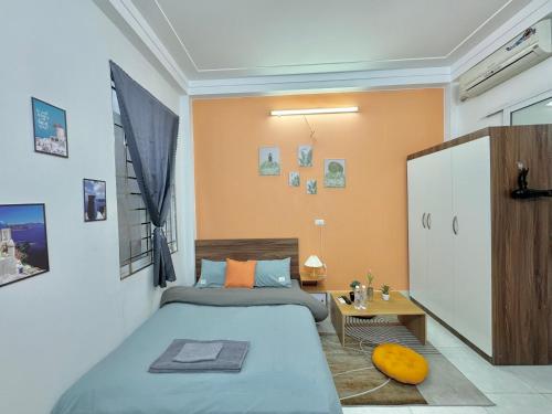 a small bedroom with two beds and a table at Sweet home * Center * Cozy in Hanoi