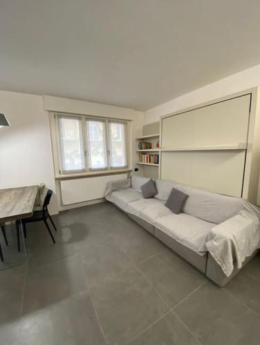 a bedroom with a bed and a table in it at Modern apartment on the beach in Nago-Torbole