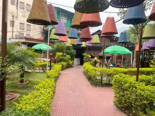 a walkway with many colored umbrellas in a garden at Hotel View Salleri in Kathmandu