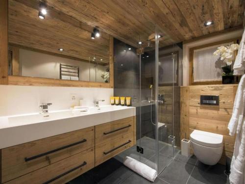 a bathroom with a shower and a sink and a toilet at Luxury Apartment in Crans Montana by Dieckereise in Crans-Montana