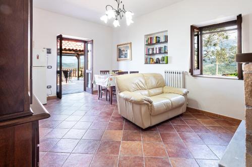 a living room with a chair and a table at Bellezza In Cilento Panoramic Apts in Castellabate