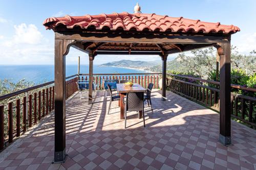 a gazebo with a table and chairs on a deck at Bellezza In Cilento Panoramic Apts in Castellabate