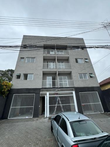 a building with a car parked in front of it at Flat Braganca in Bragança Paulista