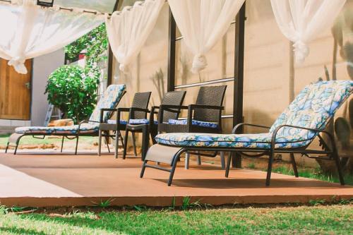 a group of chairs sitting on a patio at Contemporary Gem: Studio with Serene Pool View in Newcastle