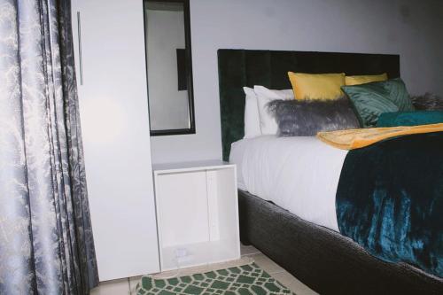 a bedroom with a bed and a mirror on the wall at Contemporary Gem: Studio with Serene Pool View in Newcastle