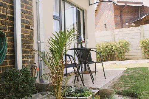 a black chair sitting on the porch of a house at Contemporary Gem: Studio with Serene Pool View in Newcastle