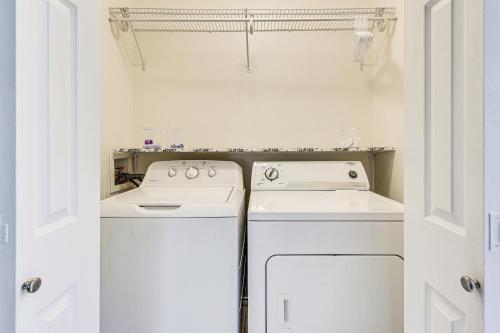 a white kitchen with a stove and a dishwasher at Pet-Friendly Edinburg Townhome - Near Stadiums! in Edinburg