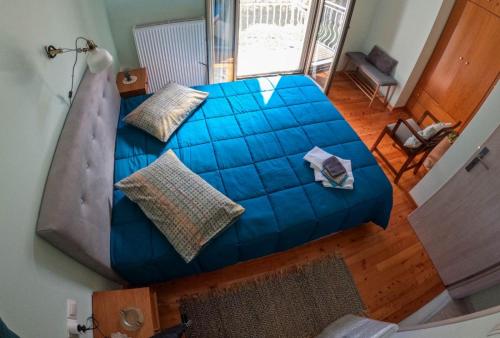 an overhead view of a blue bed in a room at Estia guest house in Olympia