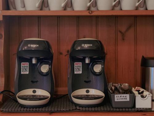 two coffeemakers are sitting on a shelf at The Kildare in Skegness