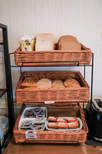 a stack of baskets with bread and other food at The Kildare in Skegness
