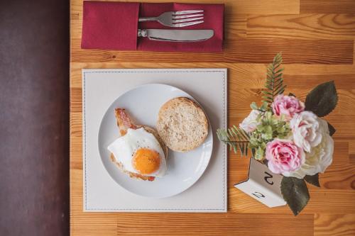 a plate with an egg and bread on a table at The Kildare in Skegness