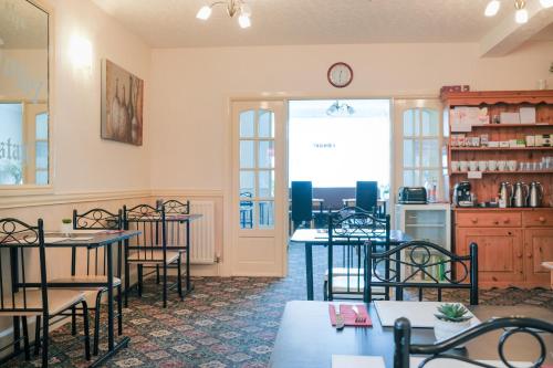 a restaurant with tables and chairs in a room at The Kildare in Skegness