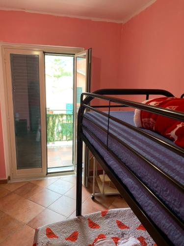 a bedroom with a bunk bed and a balcony at Il Marinaio in Messina