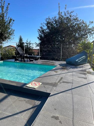 a swimming pool in a yard with a blue pool at The Farm House.23 in Funchal