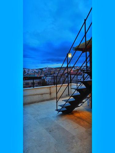 a staircase on top of a building at night at Yellow Stone House in Goreme