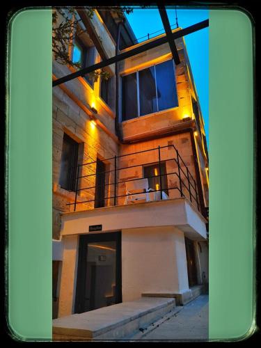 a building with a balcony on the side of it at Yellow Stone House in Goreme