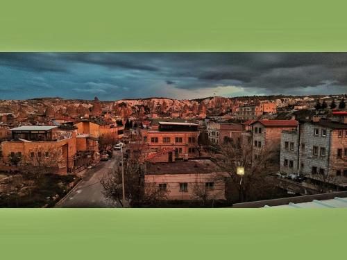 a view of a city with buildings and mountains at Yellow Stone House in Goreme