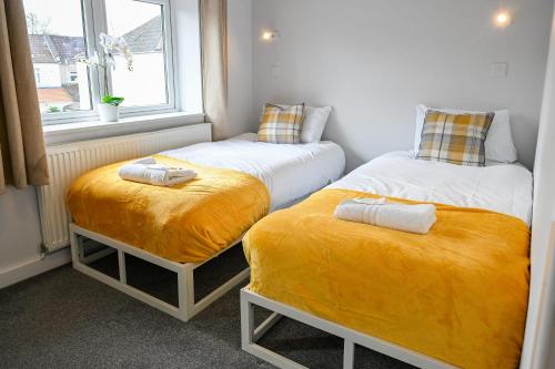 two twin beds in a room with a window at Dings House With FREE Parking In Super Central South West City Location By STAE-Homes in Bristol