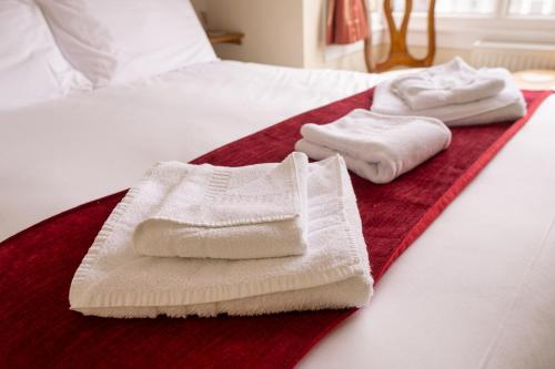 two towels are sitting on top of a bed at The Kildare in Skegness