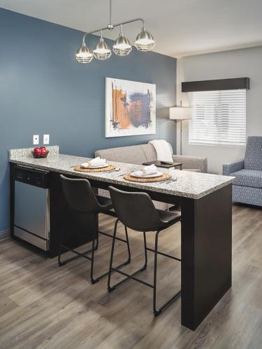 a kitchen with a large island in a living room at stayAPT Suites Tallahassee-Capitol in Tallahassee