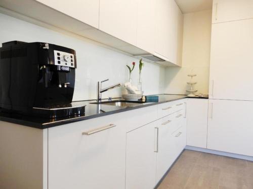 una cucina con lavandino e forno a microonde di Gemütliche 2 12 - Parterre-Ferienwohnung mit Terrasse - b48858 