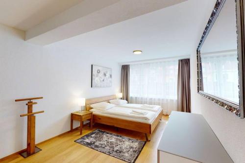 a bedroom with a bed and a cross on the wall at Amazing/sunny 2 bedroom flat in the city center (West 6) in Zurich